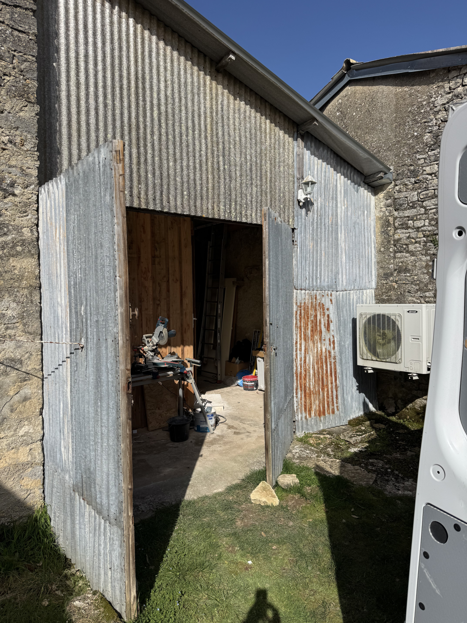 Ancienne façade de dépendance en tôles ondulées avant rénovation